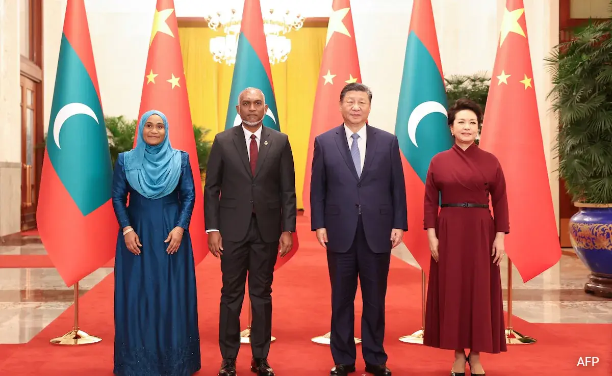 Diplomatic meeting between Indian and Maldivian officials, shaking hands in a formal setting.