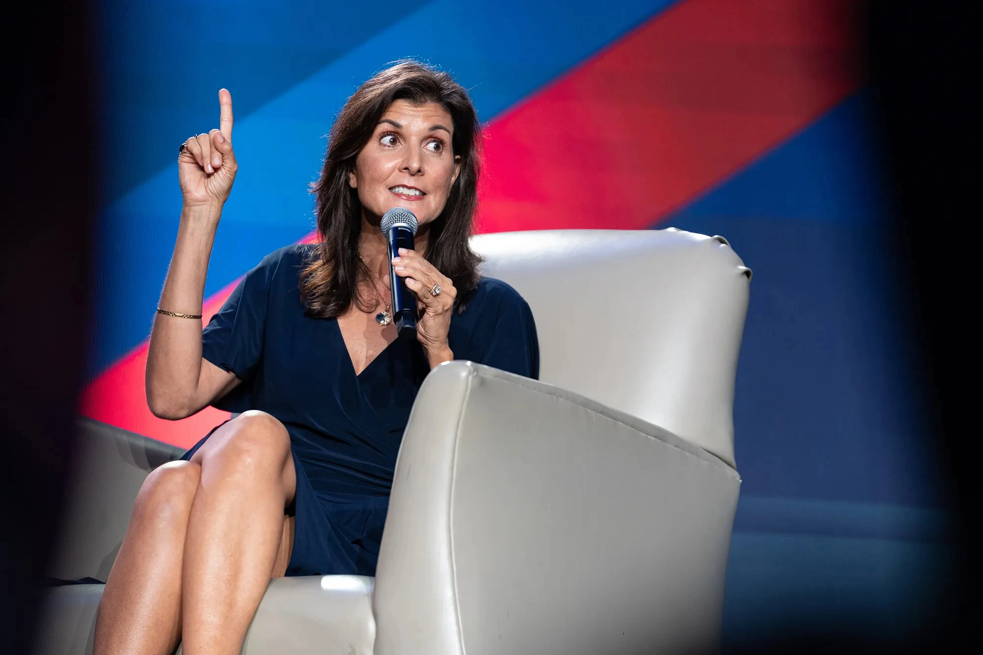 Nikki Haley 2024: Nikki Haley speaking at a campaign rally, surrounded by enthusiastic supporters and campaign banners.
