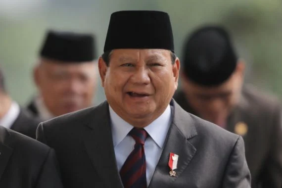 Prabowo Subianto, seorang tokoh politik Indonesia, tersenyum sambil memberikan pidato di depan pendukungnya