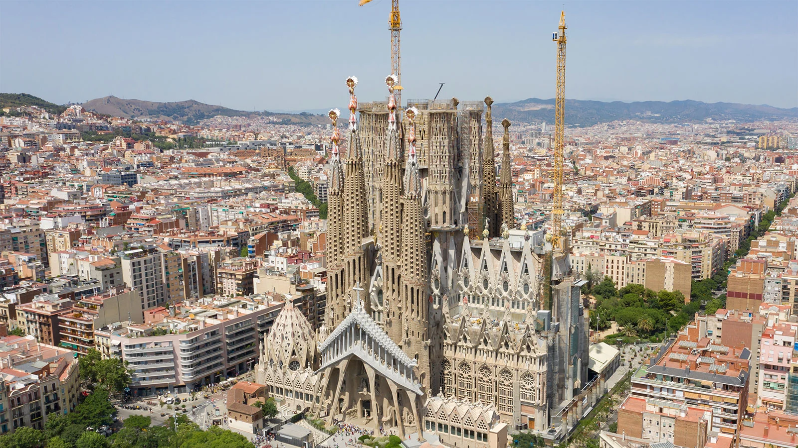 Basilica: Exterior view of the Sagrada Familia showcasing its towering spires and intricate facade