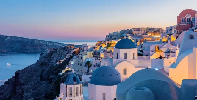 Santorini's Red Beach with striking red volcanic cliffs and clear waters.