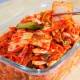 A traditional clay jar filled with fermented kimchi, representing the rich history and cultural significance of the dish in Korean cuisine.