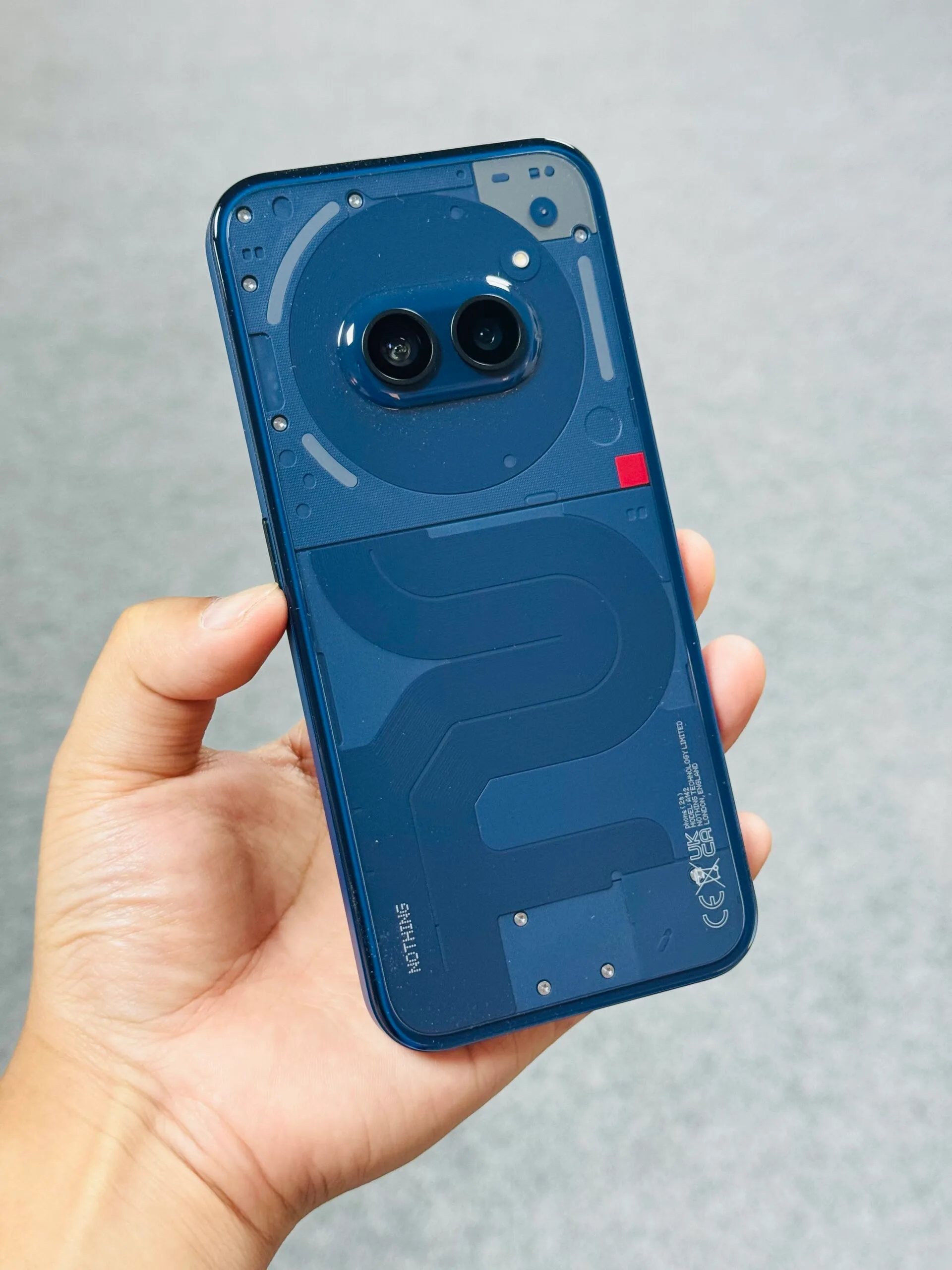 Nothing Phone (2a) showcasing its transparent back design with the distinctive Glyph Interface illuminated.