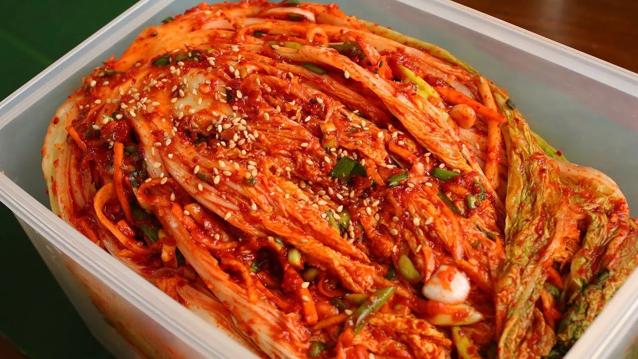 Various types of kimchi displayed on a table, showcasing the diversity and regional variations of the dish in terms of ingredients, flavors, and preparation methods.