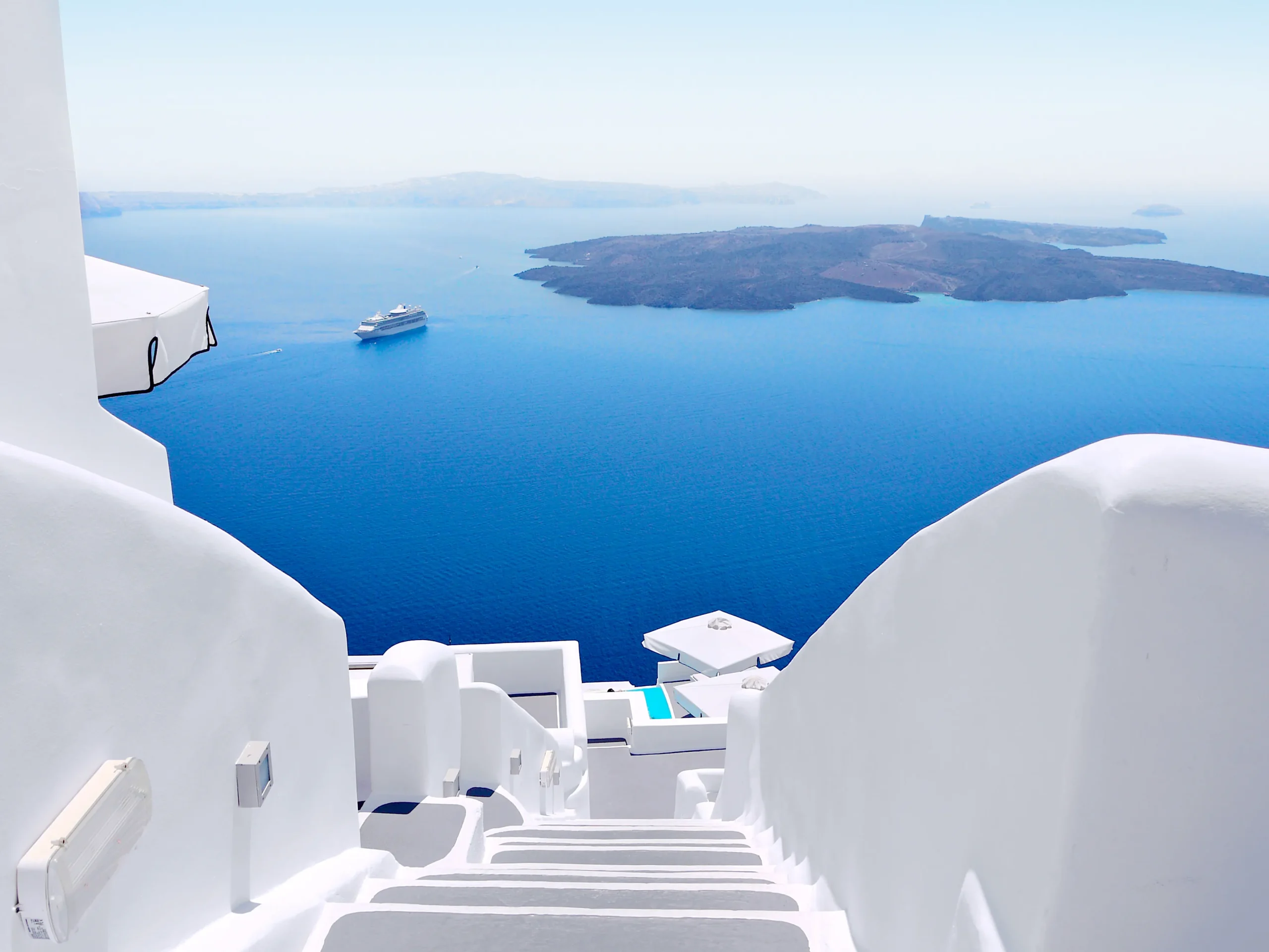 Charming village of Oia in Santorini featuring blue-domed churches and narrow streets.