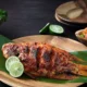 Hidangan ikan nila kecap yang menggugah selera, disajikan dengan saus kecap manis dan taburan daun bawang